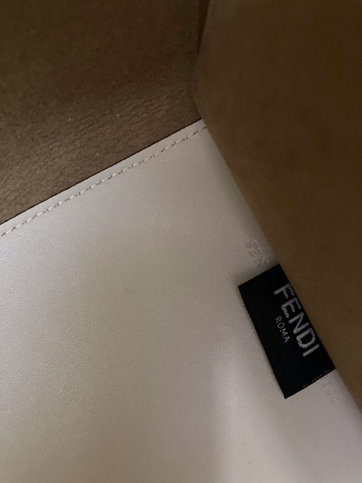 black logo tag with serial on leather