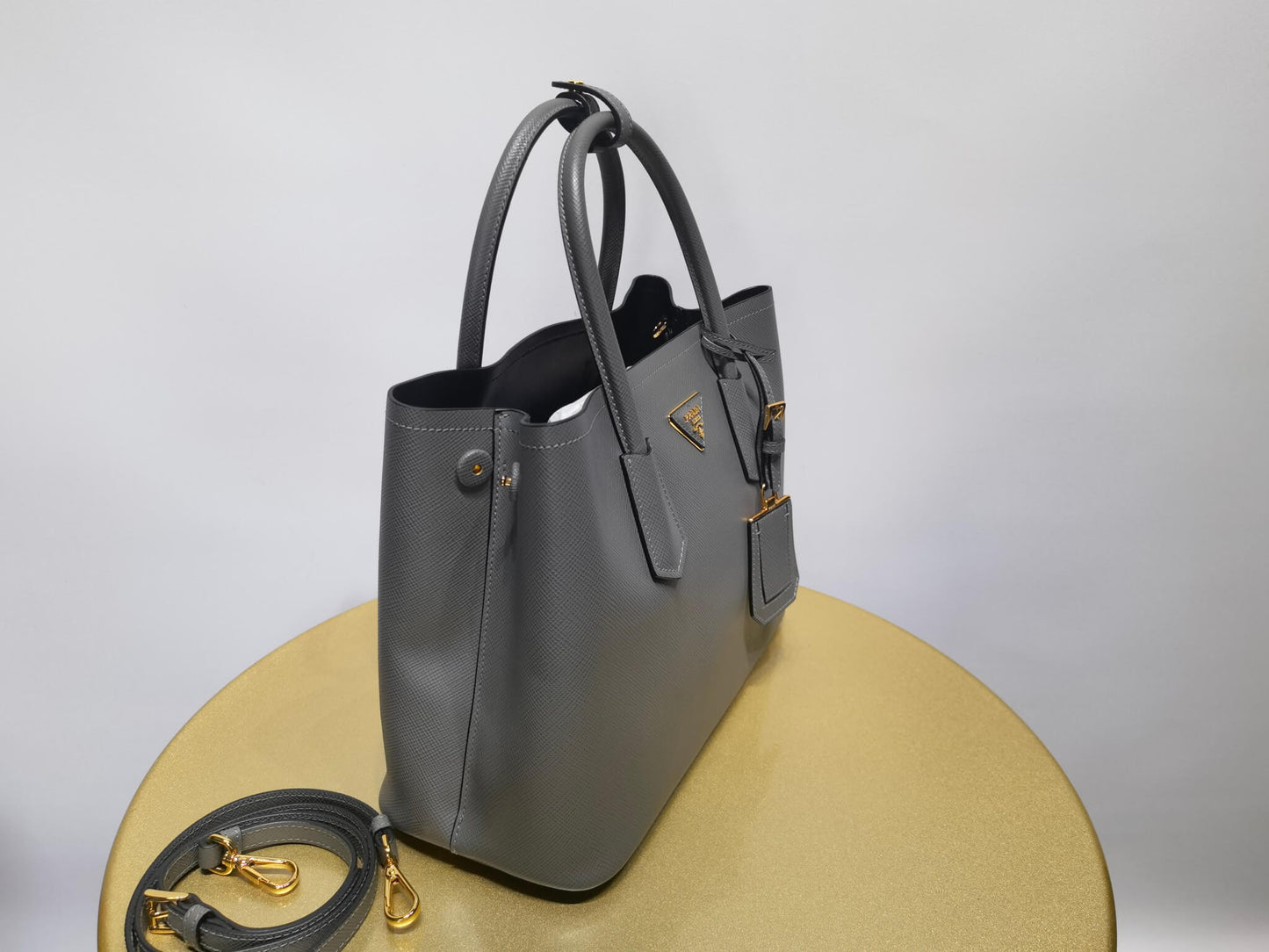 pra 1bg775 handbag double saffiano 33cm grey lambskin equipped with double handles detachable shoulder straps and soft sheepskin lining paired with gold accents