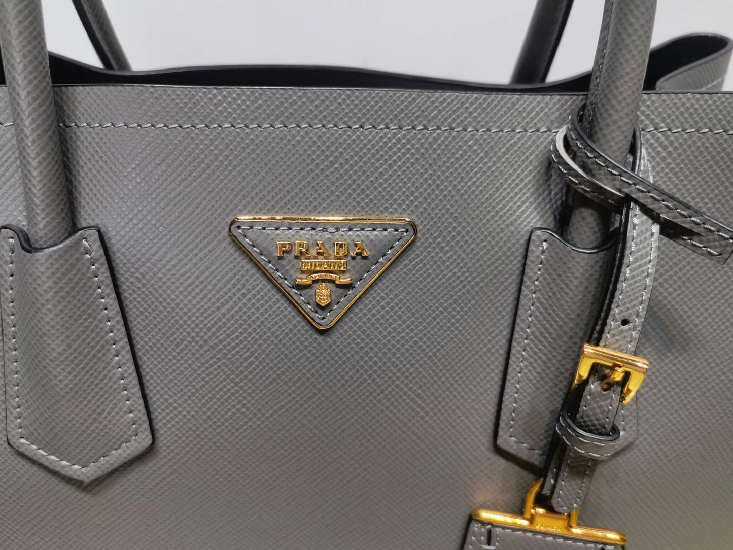 pra 1bg775 handbag double saffiano 33cm grey lambskin equipped with double handles detachable shoulder straps and soft sheepskin lining paired with gold accents