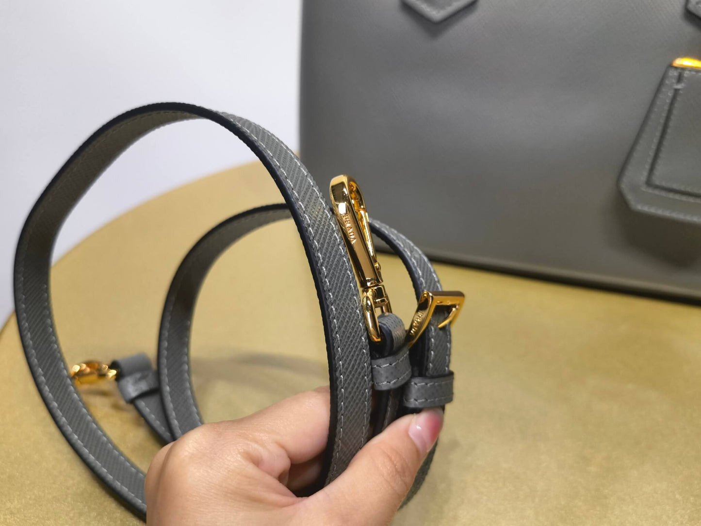 pra 1bg775 handbag double saffiano 33cm grey lambskin equipped with double handles detachable shoulder straps and soft sheepskin lining paired with gold accents