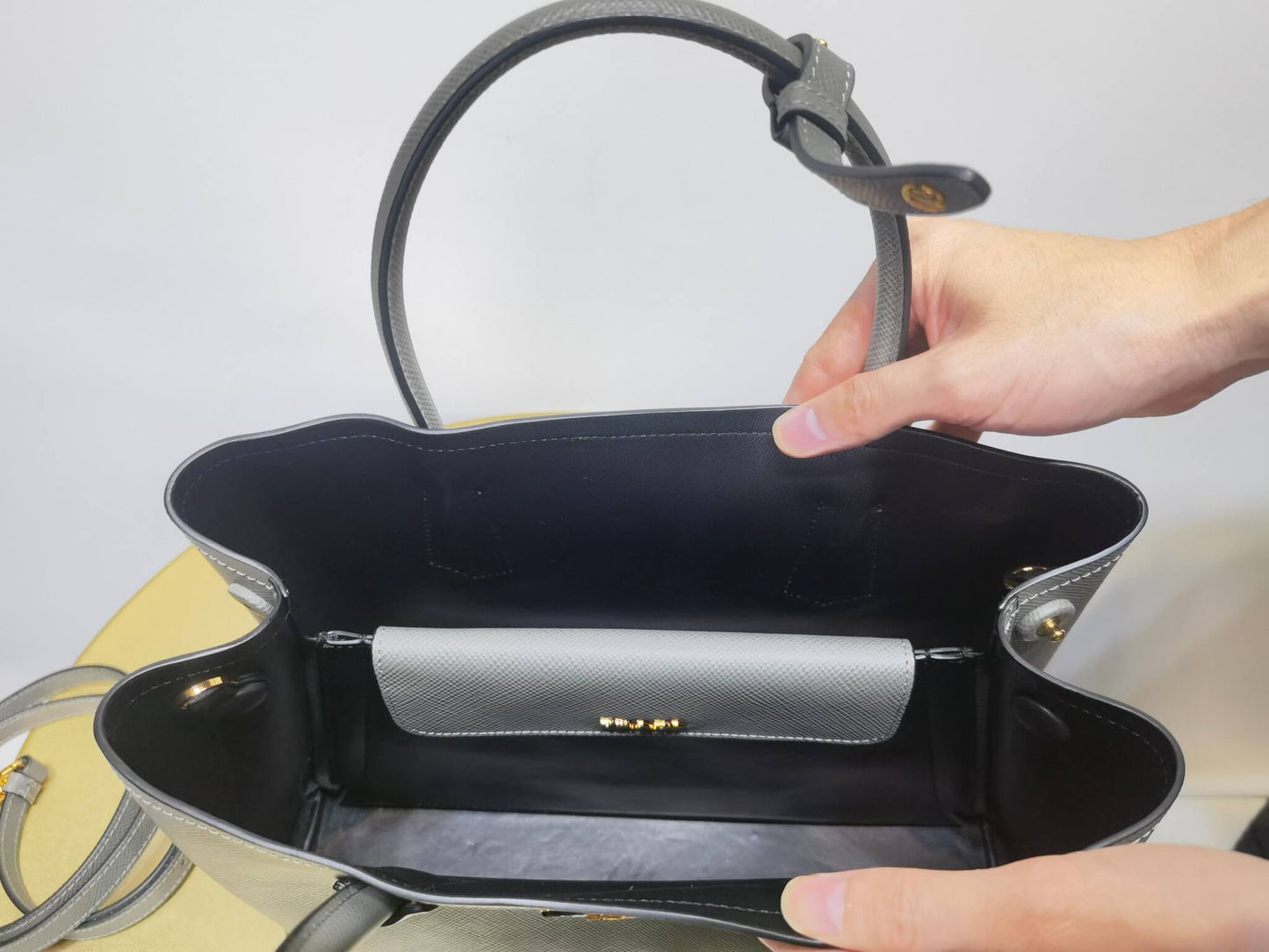 pra 1bg775 handbag double saffiano 33cm grey lambskin equipped with double handles detachable shoulder straps and soft sheepskin lining paired with gold accents