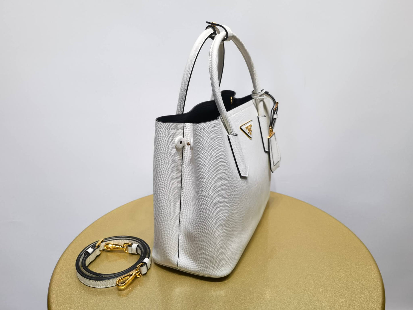 pra 1bg775 handbag double saffiano 33cm milk white lambskin equipped with double handles detachable shoulder straps and soft sheepskin lining paired with gold accents