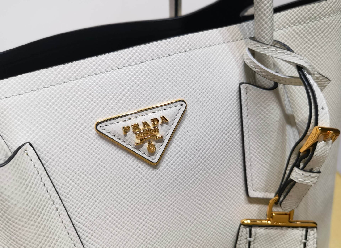 pra 1bg775 handbag double saffiano 33cm milk white lambskin equipped with double handles detachable shoulder straps and soft sheepskin lining paired with gold accents