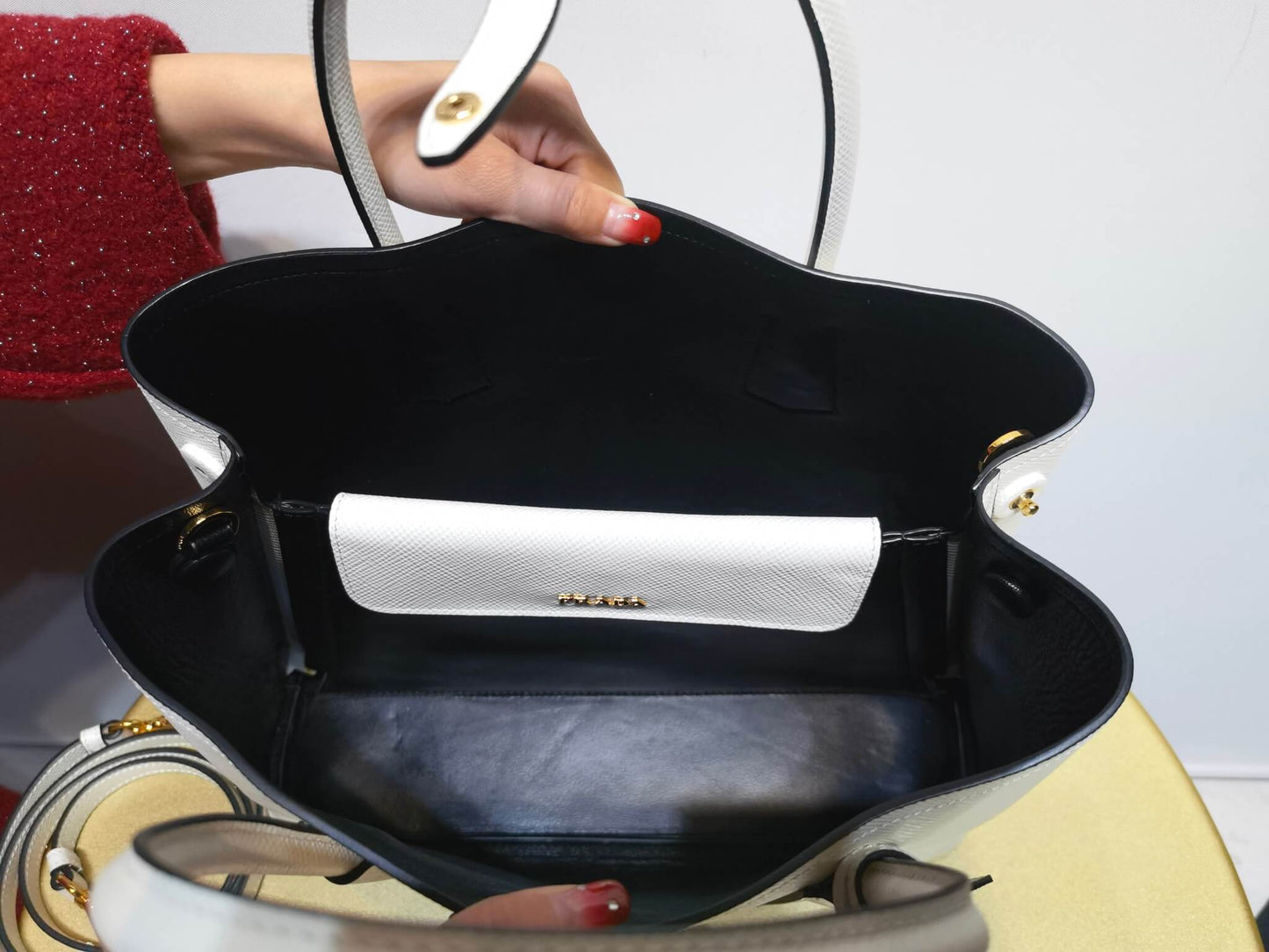 pra 1bg775 handbag double saffiano 33cm milk white lambskin equipped with double handles detachable shoulder straps and soft sheepskin lining paired with gold accents