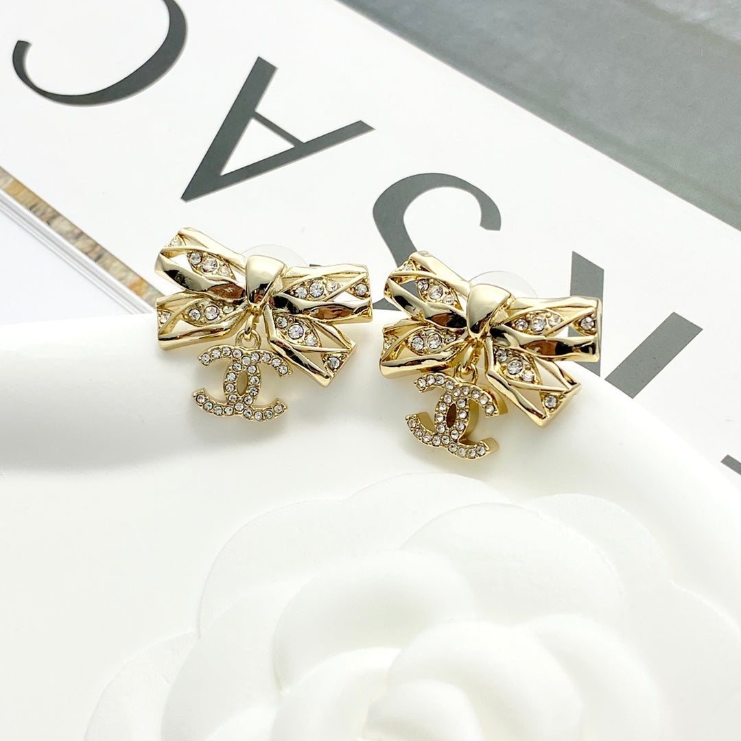 24 hollow diamond studded butterfly bow double c earrings EHA210