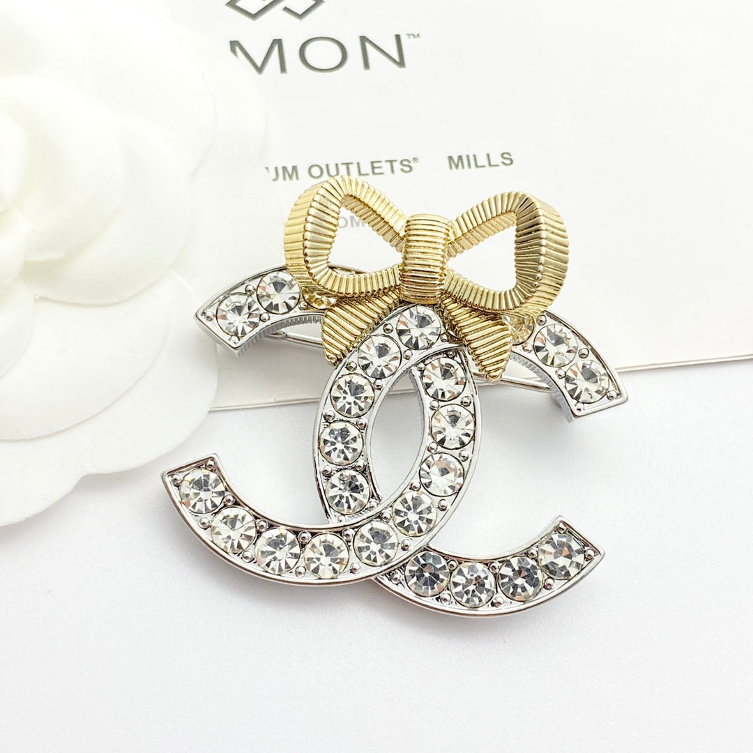 Gold and silver color blocked three-dimensional bow brooch XZA47