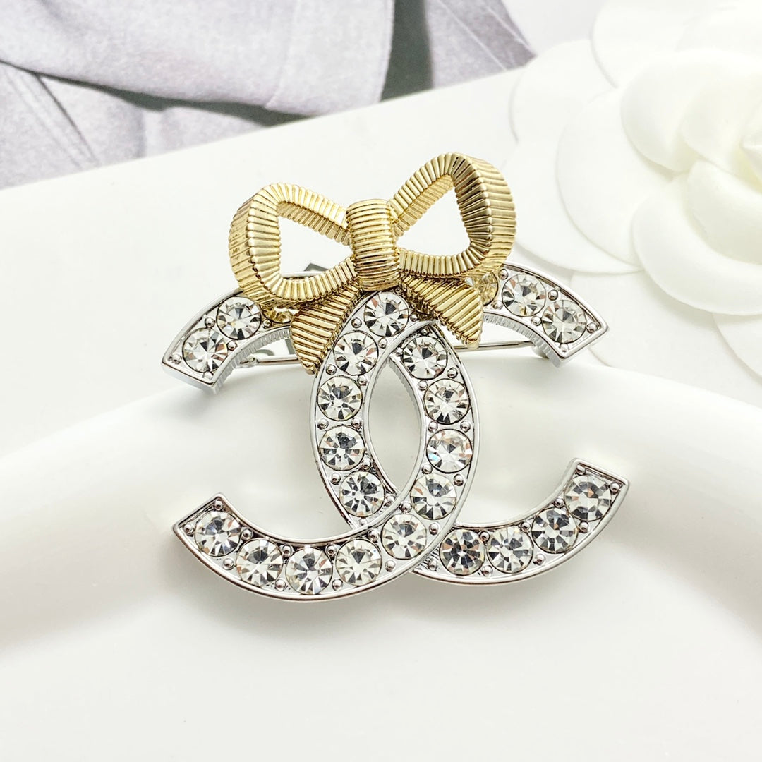 Gold and silver color blocked three-dimensional bow brooch XZA47