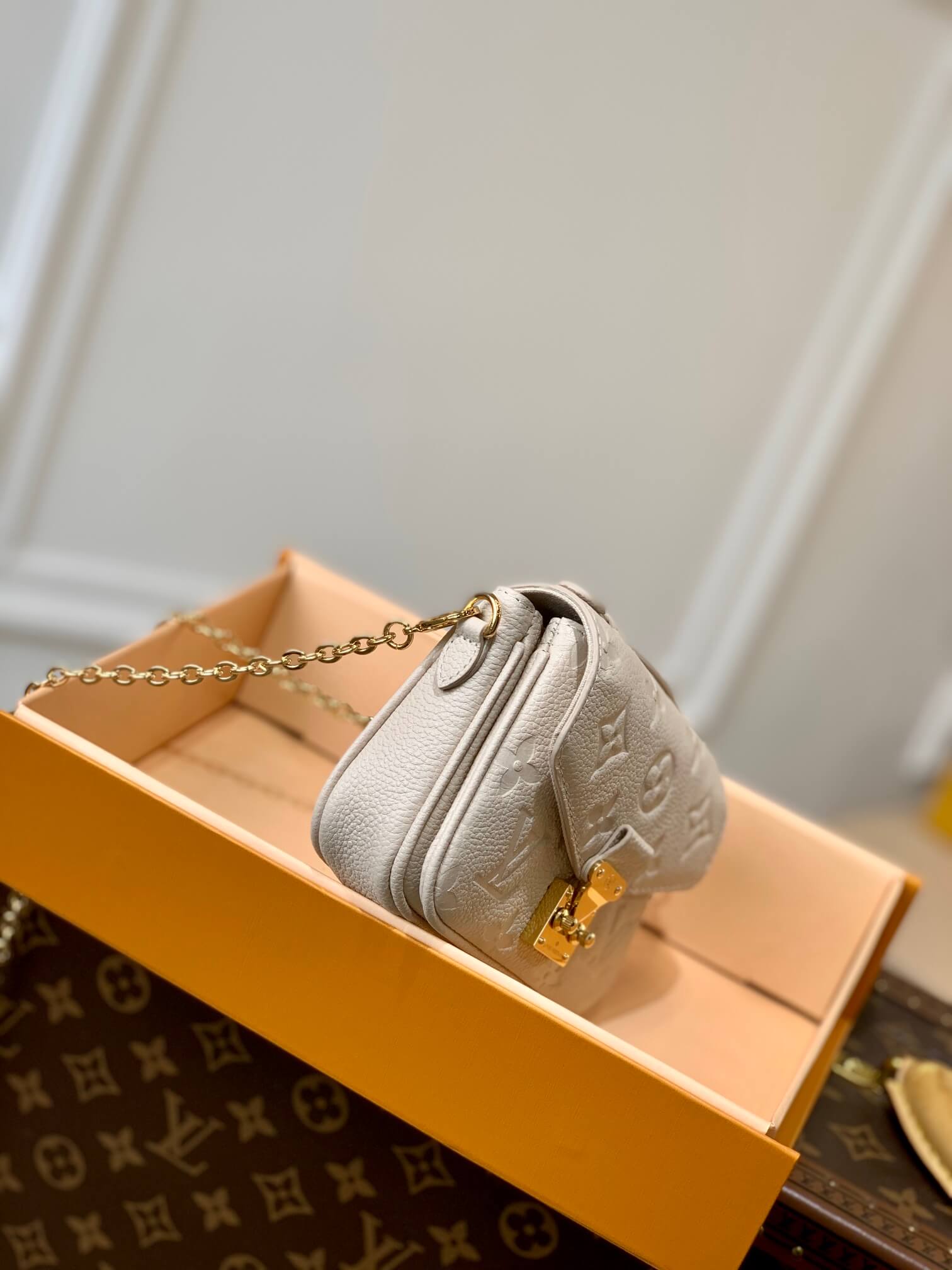 gold chain grey bag